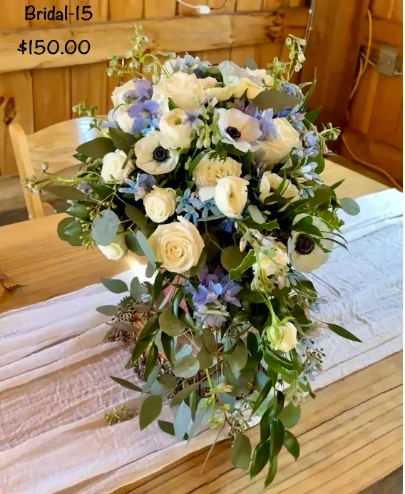 Bridal 15 — cascading bouquet of white anemones, roses and blue delphinium, $150.00